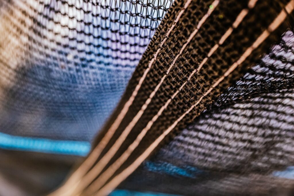 A black nylon mesh in the field to protect yourself from birds and insects.